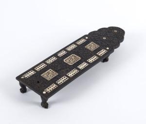 A Chinese cribbage board, carved ebony with ivory inlaid panels, 19th century, 24cm long