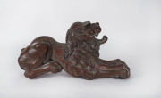 A Chinese carved wooden lion with remains of silver finish, 19th century, ​51cm long