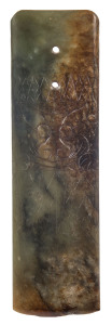 An archaic green jade axe head engraved with a pig-faced deity, Vietnamese,