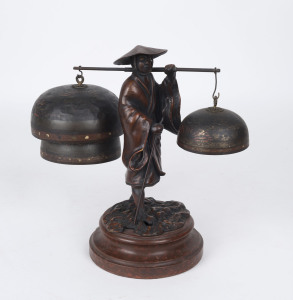 A cast metal figure of a Japanese peasant with hand painted Japanese temple bells, 28cm high