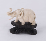 A Chinese carved ivory elephant statue on carved wooden stand, late 19th early 20th century, ​7cm high overall