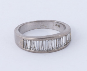 An 18ct white gold ring set with 12 trapezoid step cut white diamonds, stamped "18ct", 5.7 grams total