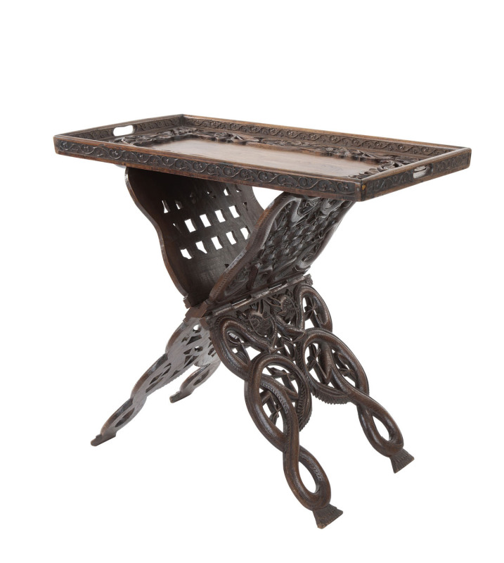 An Anglo-Indian folding tea table with carved dragon and foliate motif, 19th century, remains of makers label on base, ​67cm high, 73cm wide, 42cm deep