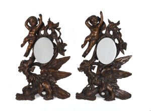 A pair of French table mirrors, ornately carved fruitwood with cherubs and griffins, mid 19th century, ​65cm high