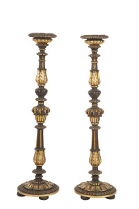 A pair of Florentine candle stands, ebonised and carved wood with gilded highlights, 20th century, 99cm high