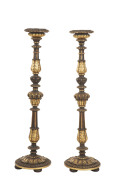 A pair of Florentine candle stands, ebonised and carved wood with gilded highlights, 20th century, ​99cm high