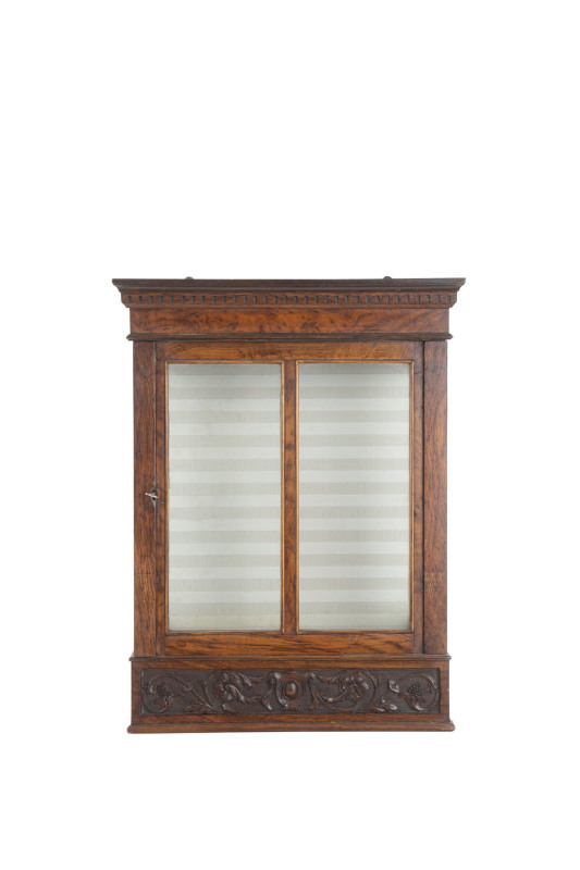 A continental wall mounted display cabinet, carved walnut and glass, ​19th century, 56cm high, 43cm wide, 22cm deep