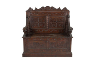 A Continental hall seat, carved oak with lions head hand grips, 19th century, 108cm high