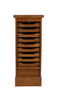 An antique filing cabinet with tambour front and lectern top, oak, circa 1900, 117cm high, 49cm wide, 44cm deep