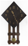 An Arts and Crafts mantel clock, English oak case with brass numerals, time and strike movement, circa 1910, 84cm high