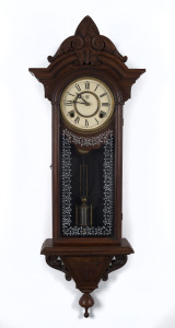 WATERBURY CLOCK Co. American wall clock with 8 day time and strike movement in walnut case, 19th century, ​86cm high PROVENANCE The Tudor House Clock Museum, Yarrawonga