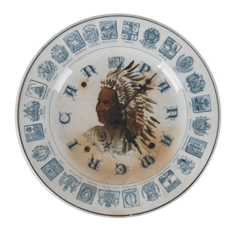 "SOUVENIR PAN AMERICAN" Exposition porcelain plate wall clock with hand-painted American Indian, circa 1901, ​21cm diameter PROVENANCE The Tudor House Clock Museum, Yarrawonga