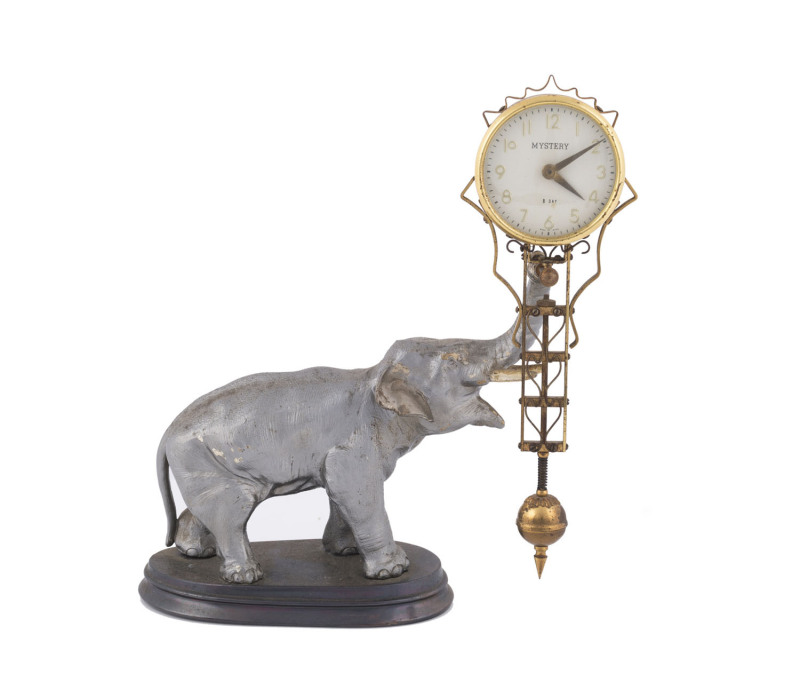 A Japanese Mystery clock on cast metal elephant base, 8 day movement, circa 1950, ​29cm high