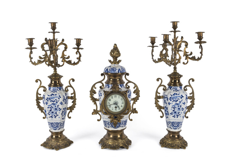 An antique Continental mantel clock set, blue and white porcelain with gilt metal mounts and five branch candelabra garniture, ​late 19th century, the garnitures 65cm high