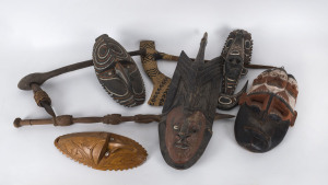 Papua New Guinea tribal masks (5), tribal axes (2), and a carved walking stick, 20th century, the walking stick 89cm high