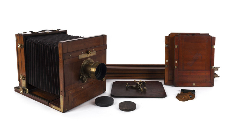 Mahogany and brass full plate tailboard camera, for 8½" x 6½" images [21 x 16cm]; unknown maker, circa 1880s. With burgundy square bellows; separate bellows adjustment and racking with centre screw to main frame. Mostly original parts with some expertly r