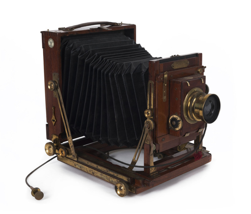 HOUGHTON: The Favourite Victo (made for Harringtons Ltd) mahogany & brass half-plate camera; with Beck symettrical lens mounted on a Thornton Pickard shutter; original bellows, cable release.