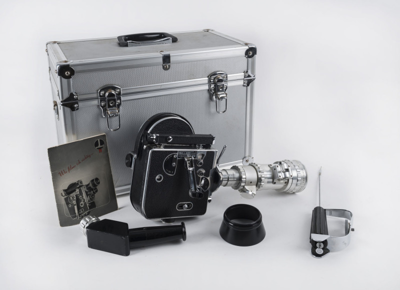 PAILLARD BOLEX 16mm movie camera, non-reflex H Model, early 1950s [#89051] with SOM Berthiot 3.4/f25:100 lens that allows reflex viewing; lens cap, lens shade, rewind crank, surefire handgrip, cable, takeup spool, user manual and fitted aluminium carry ca