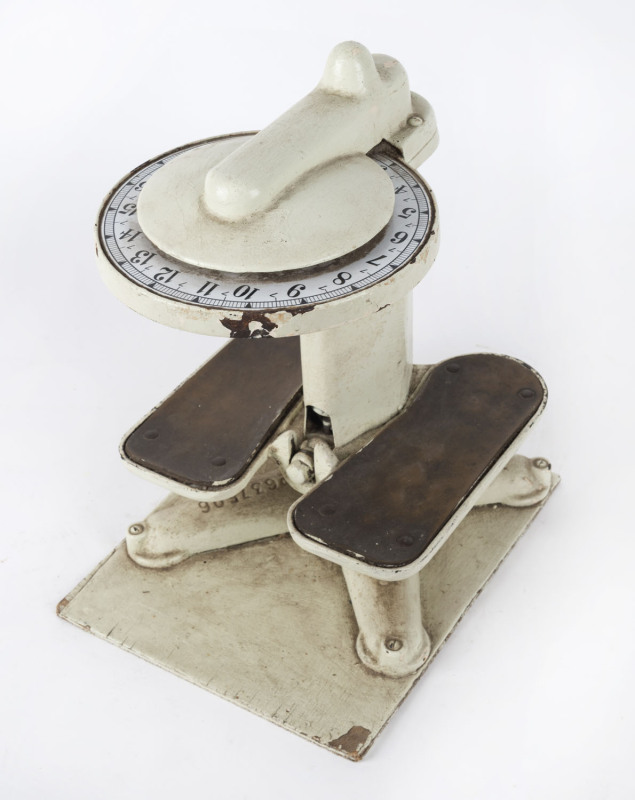 A set of antique bathroom scales, metal and brass with enamel dial, late 19th century, 33cm high