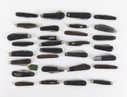 Thirty three folding pocket knives mostly horn and ebony handles, mostly Sheffield, England, 19th and 20th century, the largest 17.5cm