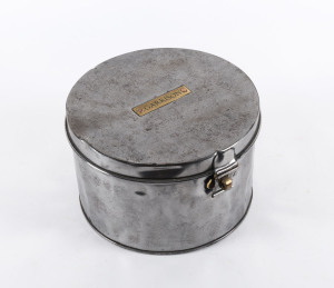 An antique hat tin, metal with brass plaque "GARRISON", 19th century, ​17cm high, 27cm diameter