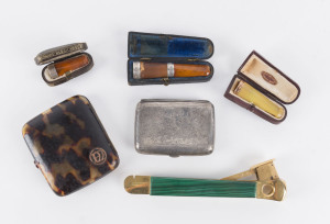 Cigar cutter with malachite handle, sterling silver cigarette case, tortoiseshell and rose gold cigarette case; plus three cigar holders made from amber with sterling silver and rose gold mounts (in fitted cases), 19th and early 20th century.the cigar cut