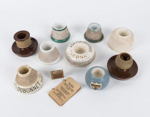 Nine antique and vintage match holders including DUBONNET Grand Prix 1900 Vin Au Quinquina, SEDNA and others, 19th and 20th century, ​Dubonnet 10cm across the base