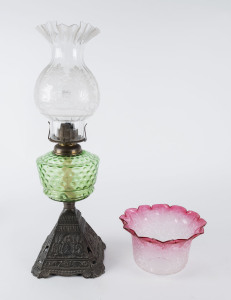 A kerosene lamp with green glass font, acid etched shade with single burner; together with a ruby glass shade, 54cm high