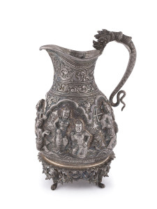 A Burmese silver jug with high relief repousse work, 19th century, 18cm high, 370 grams