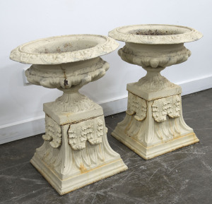A pair of antique cast iron garden urns with cream painted finish, 19th century, 57cm high