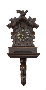 A Black Forest cuckoo shelf clock with bracket, early 20th century, clock 38cm high, 72cm overall
