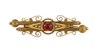 A yellow gold bar brooch set with red stone and seed pearls by T. WILLIS & SONS, Melbourne stamped "15ct, W" with unicorn mark 5.5cm, 5.5 grams