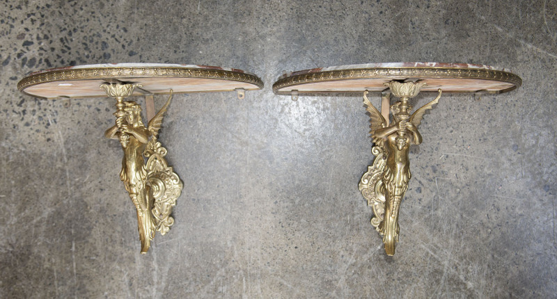 A pair of French figural demi-lune wall brackets, gilt metal and rogue marble, 19th century, 30cm high, 42cm wide, 27cm deep