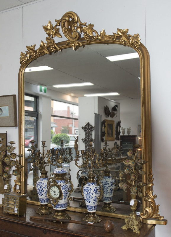 An ornate gilt overmantel mirror, English, 19th century, ​185cm high, 175cm wide
