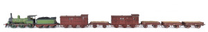 c.1875 Q Class (Q83) Steam Locomotive (195x35x50mm), green livery with gold trim, 0-6-0 wheel configuration, with rolling stock comprising two 'D' class Guard Vans and four freight wagons containing aggregate, total size 700x35x50mm. (8 items)