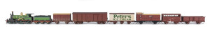 1889 A Class (A190) Steam Locomotive (200x40x55mm) built by Beyer, Peacock & Co (name plate on wheel arch), pale green livery with gold plated trim, 4-4-0 wheel configuration, rolling stock configured for 1940s branch line use with five goods carriages including a Peters Ice Cream van and Z guard carriage at the back, total size 840x40x55mm. (8 items)