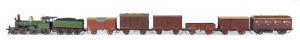 c.1877 D Class (D122) passenger Steam Locomotive (205x40x55mm) built by Rogers (Paterson, NJ, USA), dark green livery with gold plate trim, 4-4-0 wheel configuration, with rolling stock comprising five goods carriages and a YH guard passenger at the back, total size 735x40x55mm. (8 items)