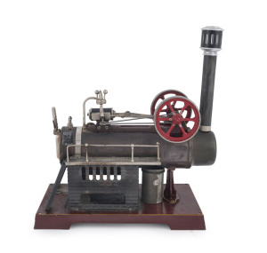 Late 1920s Doll & Co overtype stationary horizontal steam engine, ladders and boiler access platforms, on top of the boiler a single cylinder horizontal steam engine complete with two flywheels painted in red, detachable chimney with spark arrester, sits on coast iron base painted in maroon, base 25x12½cm, height 30cm, weight 1.1kg.