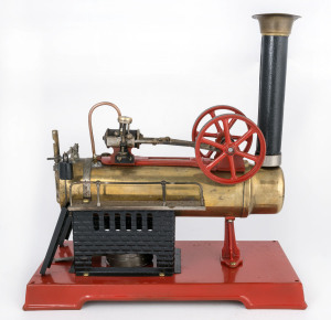 A similar item to the above - this example with brass boiler, grooved flywheels, detachable chimney but without a spark arrester, the cast iron platform painted in red, base 28x14½cm, height 29cm, weight 1.25kg.