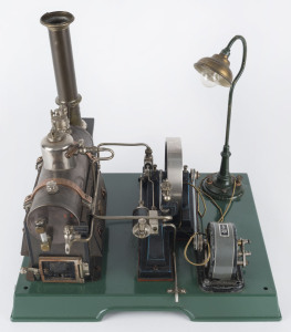 Early 1930s Marklin composite steam plant with boiler, engine, large flywheel, electric dynamo powering a lamp, Marklin “GM & Cie” maker's plates on the boiler and on the dynamo, mounted on 33x26cm cast iron base, height 30cm, weight 2.4kg.