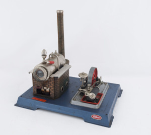 1970s Wilesco Steam Engine built from kit, nickel plated boiler, copper plated boiler house with embossed brick type walls, reversible brass cylinder with flywheel, safety valve, dome whistle, mounted on metal stand; base 26x21cm, height 25cm, weight 870gr, comes with original box with a few fuel tablets.