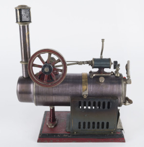 c. 1920 Falk Overtype stationary Steam Engine Type 141F (stamped on base), 7½cm diameter burnished brass boiler, 7½cm flywheel, mounted on cast iron base painted red; 18½x12½cm base, height 27cm, weight, weight 1.86kg.