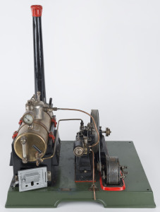 1930s Marklin composite steam plant, comprising horizontal 7cm diameter brass boiler with manometer above boiler house, engine with 12cm flywheel connected to a dynamo, Marklin name plate on dynamo and impressed on the boiler door, mounted on a 34x27½cm cast iron base, height 43cm, weight 4.1kg.