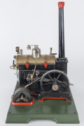 1930s Marklin composite steam plant, comprising horizontal 7cm diameter brass boiler with manometer above boiler house, engine with 12cm flywheel connected to a dynamo, Marklin name plate on dynamo and impressed on the boiler door, mounted on a 34x27½cm c - 2