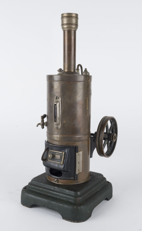 1930s Marklin vertical boiler and inverted steam engine in brass, boiler with lower fire door, water gauge, flywheel, safety valve, mounted on molded metal base, Marklin name plate on boiler, 12½x12½cm base, height 31cm, weight 950gr.