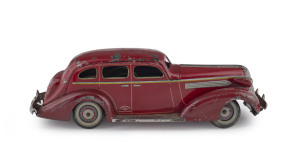 1936 red Pontiac 4-door sedan, windup car by Kuramochi; 30cm (12") long.