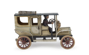 Carette two-door saloon; wind-up mechanism, manual brake, windscreen in front of driver in brown uniform; two front lamps; roof rack for luggage. Marked "GERMANY" on base plate. Length: 22cm (8.75").