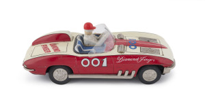 "Diamond Finger 001" Corvette Stingray speed racer with driver, pop-up machine guns under front bonnet flaps; battery powered (not tested). Made by Ichida, Japan, circa 1960. Length: 31cm (12.25").