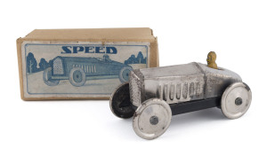 All silver "SPEED" racer with driver; friction powered in original box by Kohno Kakuzo, Japan; circa 1930s. With KK propellor logo on the chassis (behind the driver) and on the box label. Extremely scarce; the only other example known to the vendor is in the MINT Toy Museum, Singapore. Length: 13.5cm (5.25").