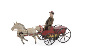 IVES CUZNER TROTTER, circa 1890, patented March 1871 by J. Cuzner and was named after him, described as "dressed driver whips horse and horse trots in very natural manner," carriage is red, driver wears brown coat, brown pants & red hat. Length: 28cm (11").